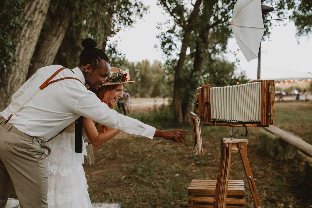 A couple admiring a photo taken by the vintage photo booth
