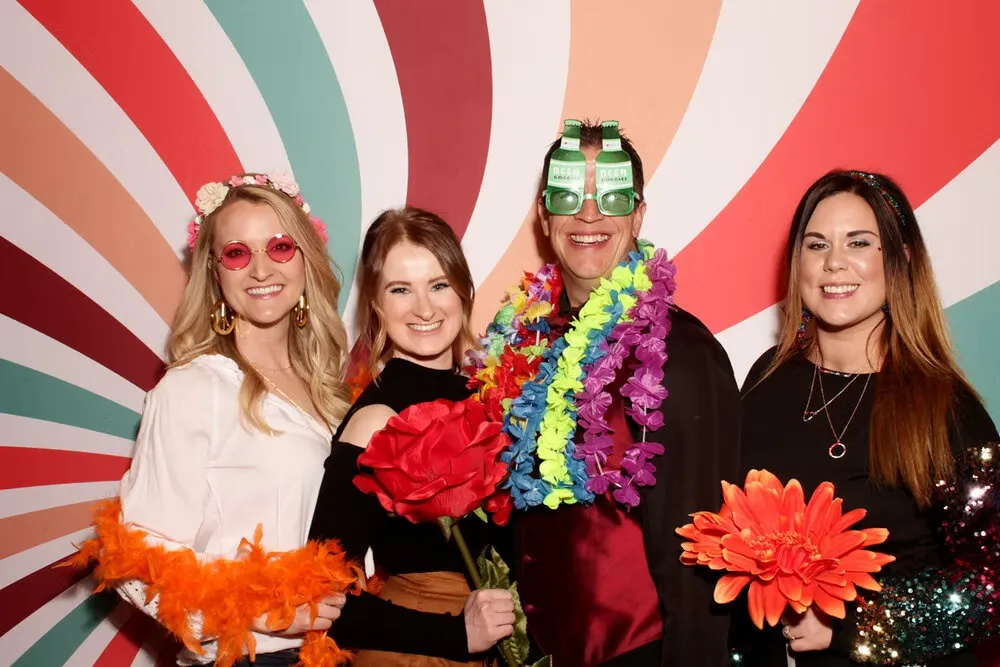 People with colorful backdrop and props