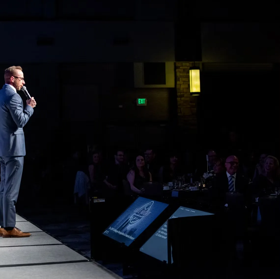 Professional photographer using SpotMyPhotos technology with facial recognition at corporate event