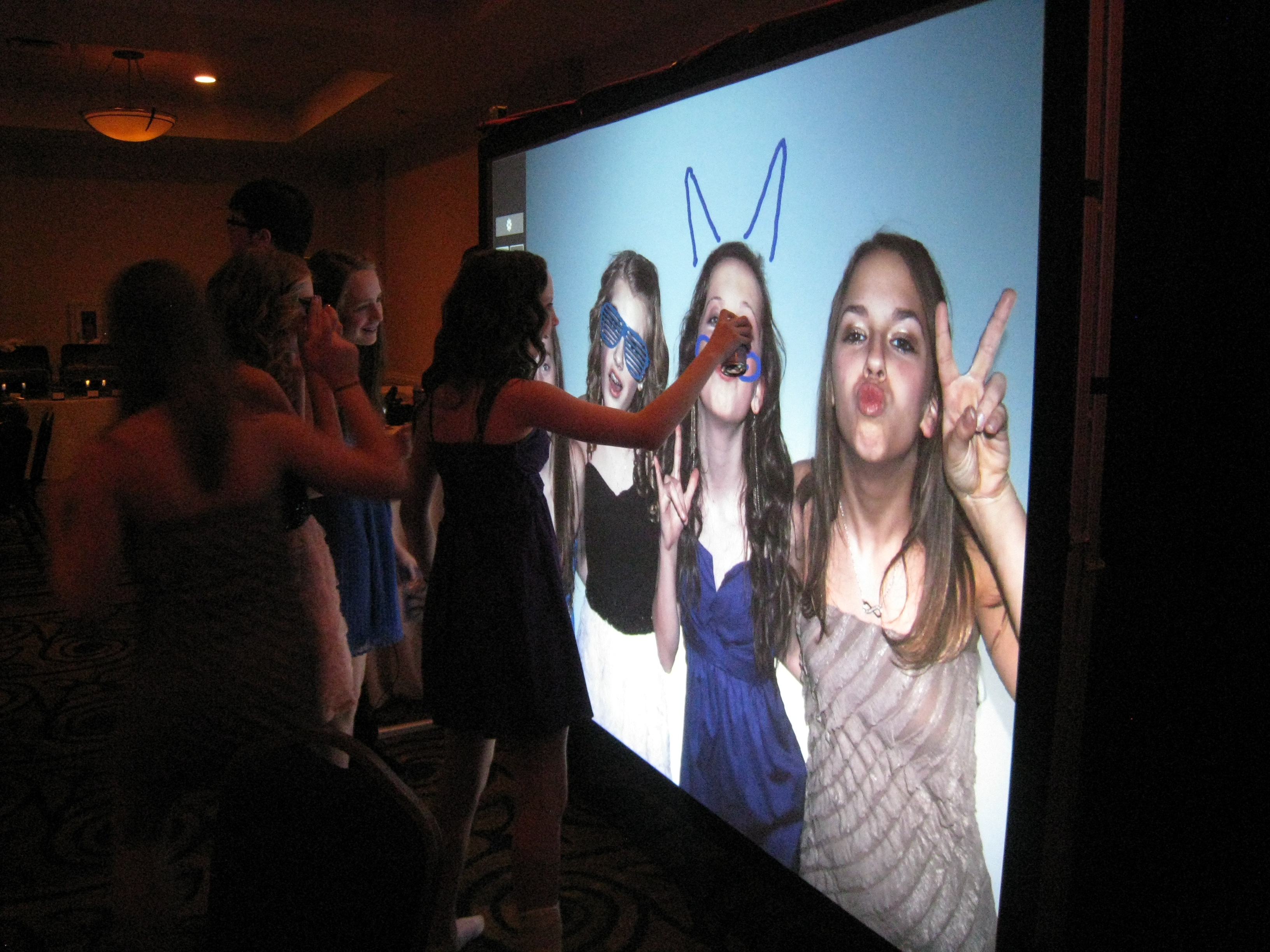 Interactive graffiti wall photo booth with digital spray paint effects