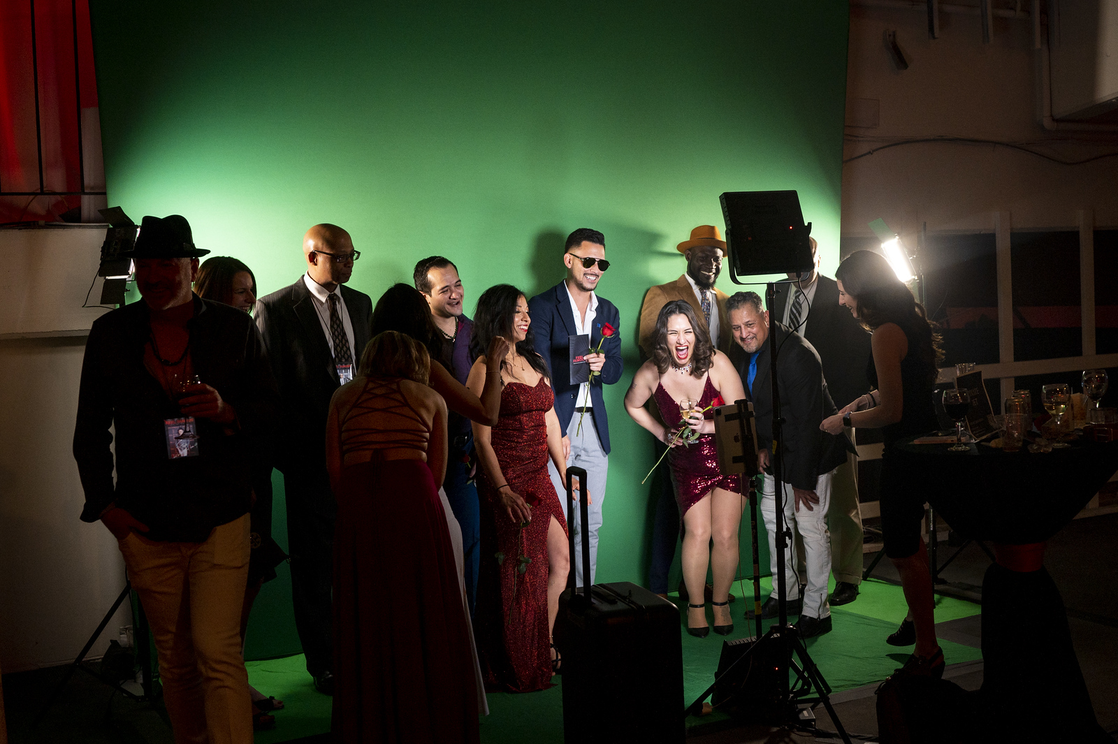 Gamers posing with neon arcade graphics green screen photo booth