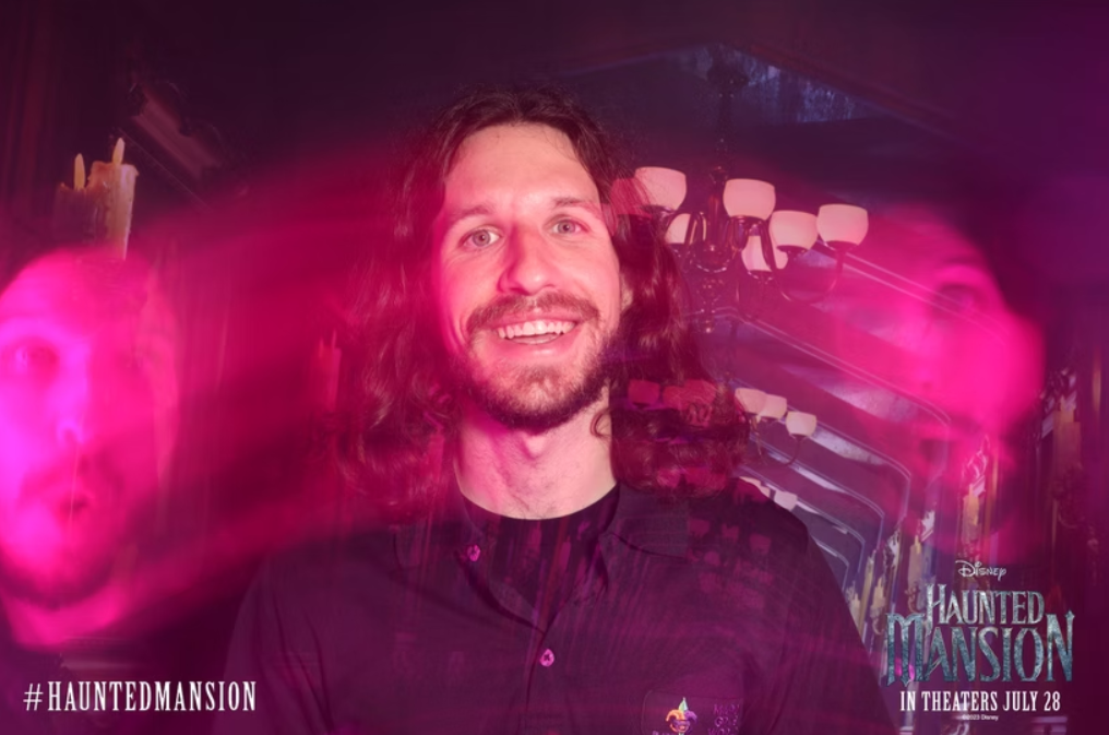 Lady with wide eyes open in front of a haunted house background