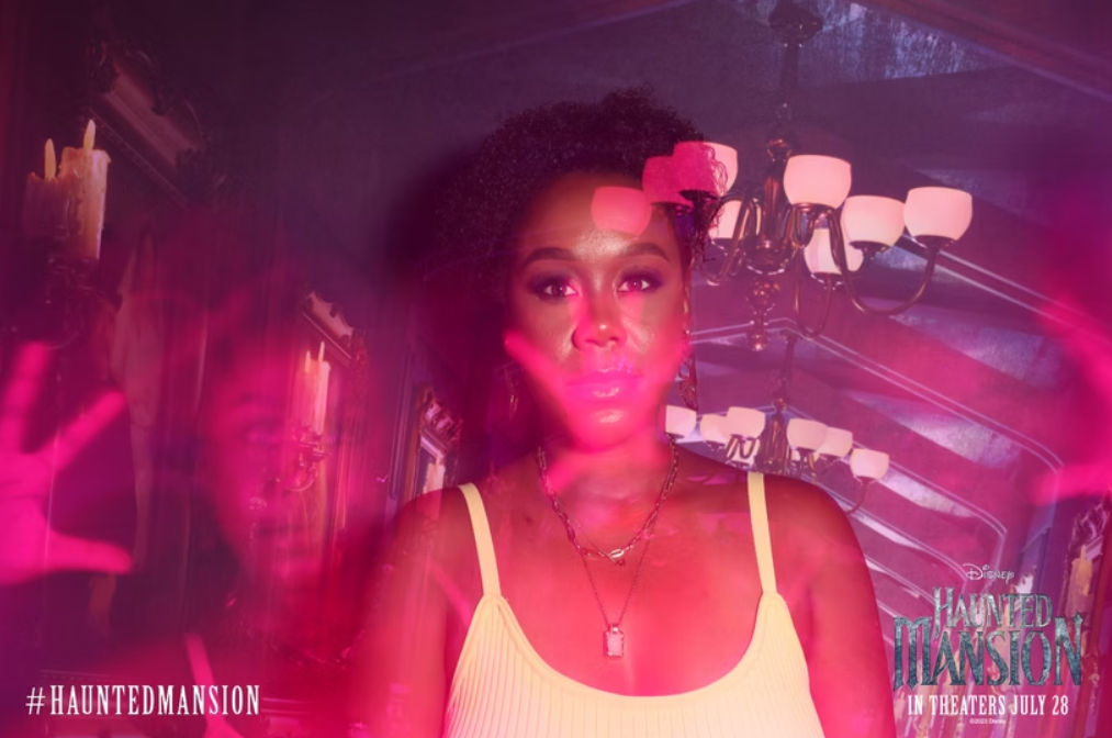 A guy smiling with ghosts around him making silly faces