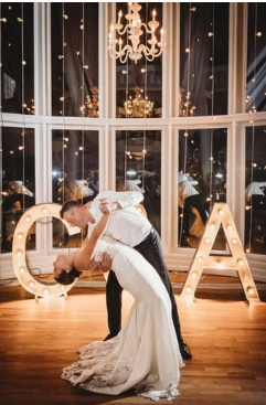 Custom marquee letters and market lights creating warm ambiance for a corporate event