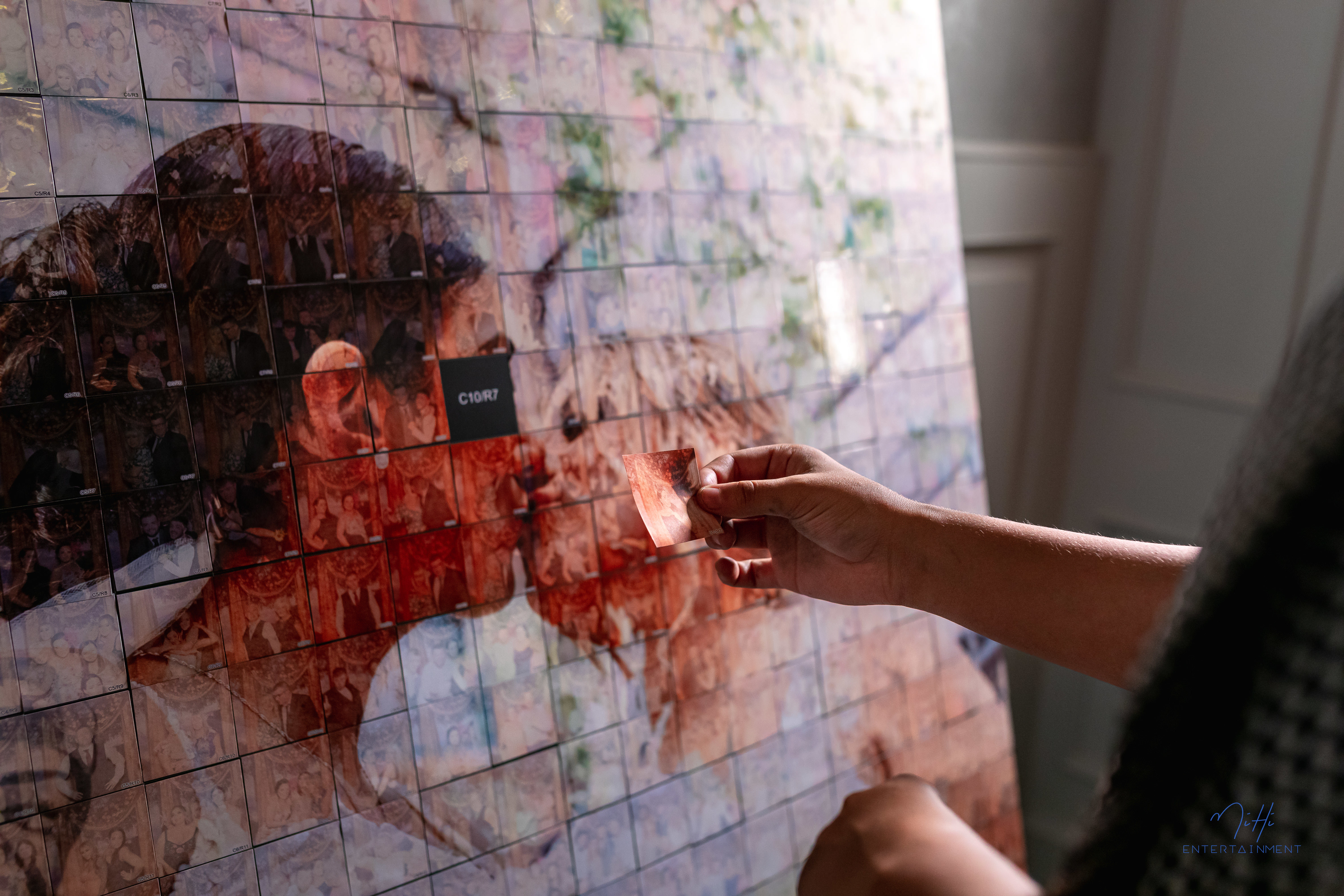 Guests interacting with mosaic photo booth at event