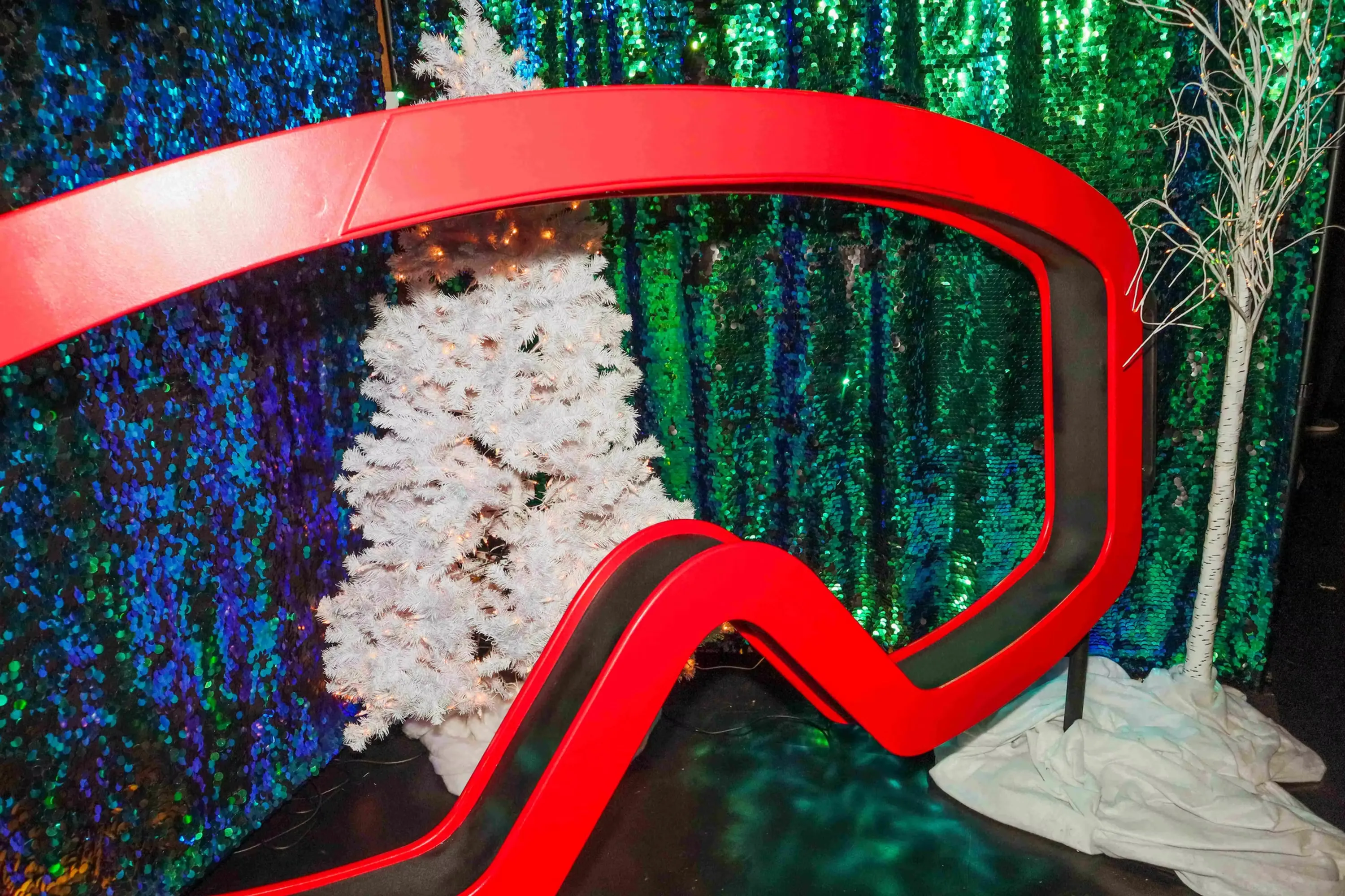 Ski lodge themed photo booth with winter wonderland decor and vibrant goggle design