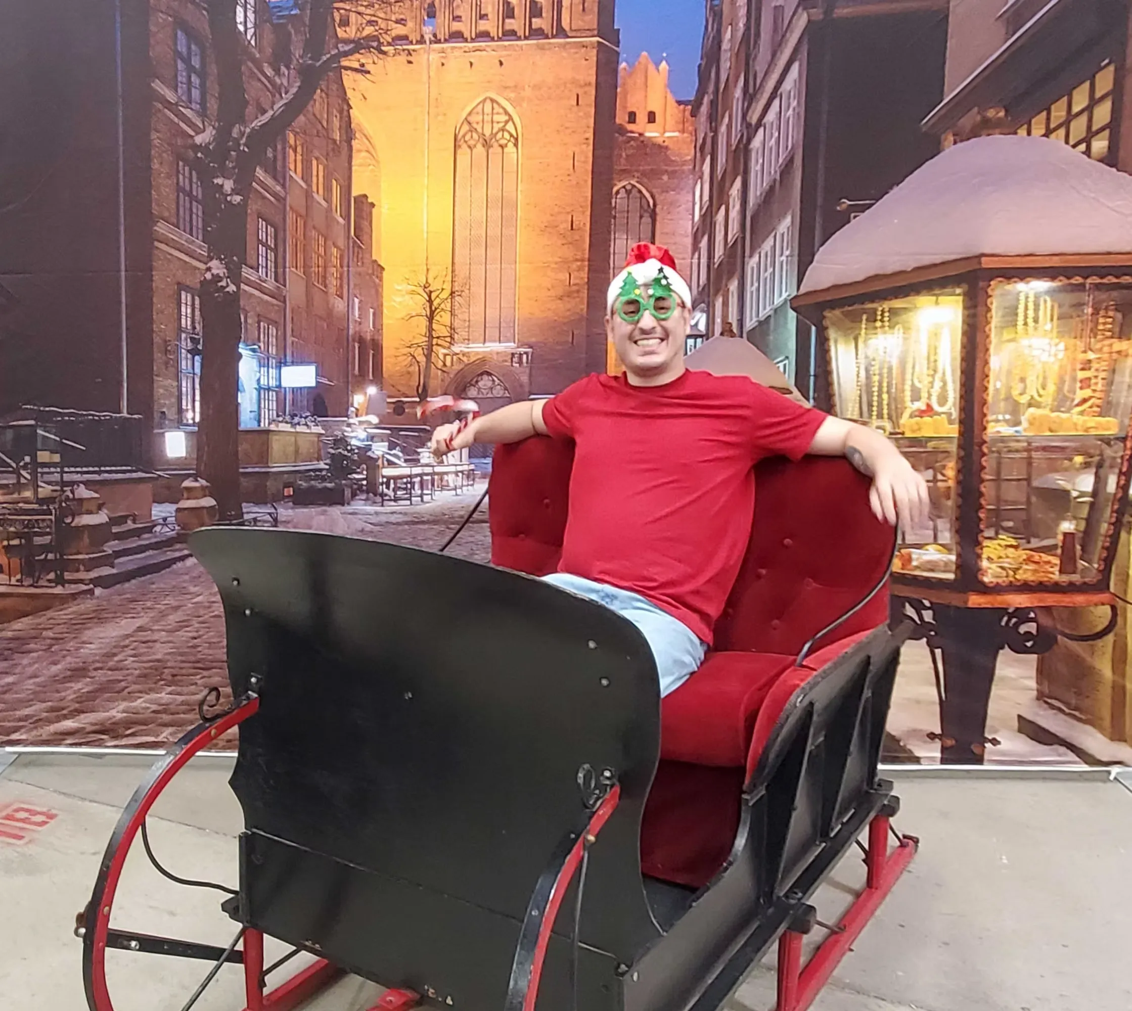 Festive sleigh photo booth set with lanterns and snow creating magical winter wonderland for events