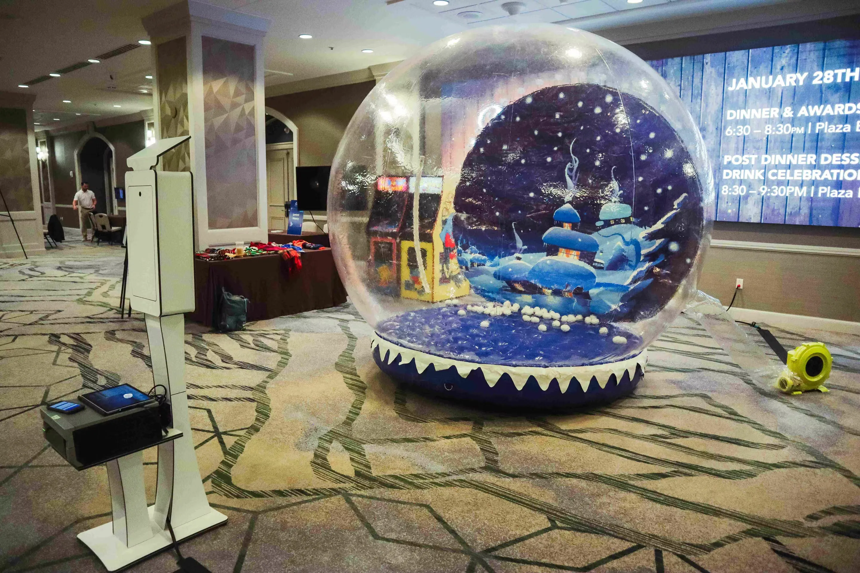 Giant inflatable snow globe photo booth creating magical winter wonderland experience for weddings and parties