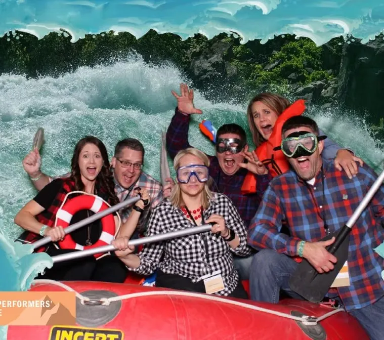 Full-sized white water raft photo booth with multiple guests creating adventurous group photos